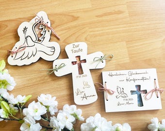 May include: Three wooden plaques with doves and crosses. The first plaque has a dove with an olive branch in its beak. The second plaque has a cross with the text "Zur Taufe" and the date "17.07.2025". The third plaque has a dove and a cross with the text "Herzlichen Glückwunsch zur Konfirmation!" and the date "17.06.2025".