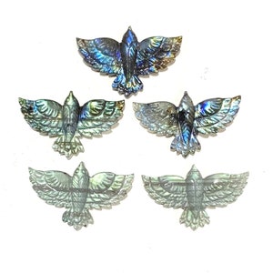 May include: Five iridescent labradorite gemstone carvings of birds with wings outstretched. The carvings are detailed and show the intricate patterns of the labradorite.