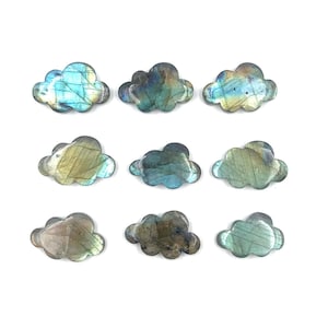 May include: Ten labradorite crystal cloud shapes in various shades of blue, green, and gold. The crystals are polished and have a smooth, iridescent surface.