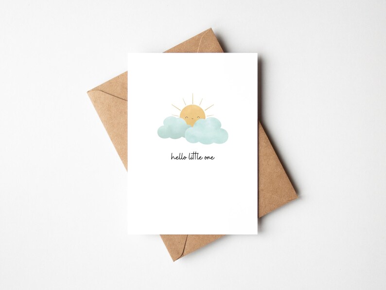 Minimalist New Baby Card that reads Hello Little One. The illustrations is of a cute, happy sunshine peeking out from behind some fluffy clouds