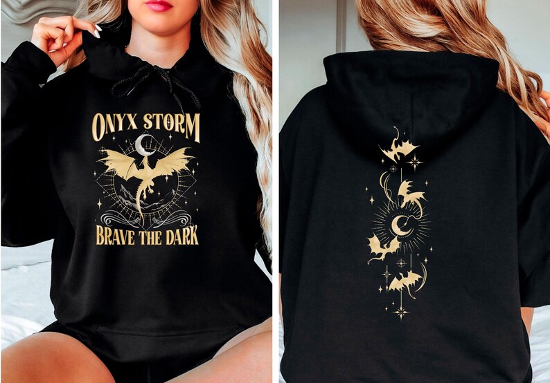 May include: Black hoodie with a gold graphic of a dragon and the text "ONYX STORM" and "BRAVE THE DARK". The back of the hoodie has a gold graphic of a crescent moon and several dragons.