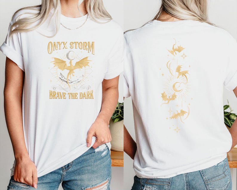 May include: White t-shirt with a gold graphic of a dragon and the text "ONYX STORM BRAVE THE DARK". The back of the shirt has a gold graphic of multiple dragons.