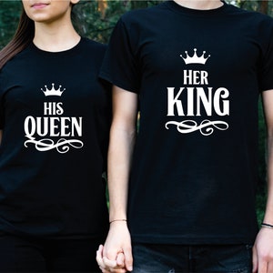 May include: Two black t-shirts with white text and a crown graphic. The text on the first shirt says "His Queen" and the text on the second shirt says "Her King".