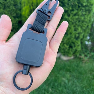 Bobine de badge rétractable en fil d'acier de haute qualité - Porte-cartes porte-clés polyvalent pour les activités de plein air et le travail