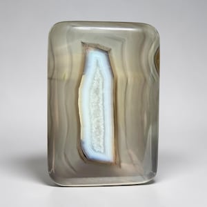 May include: A set of three ceramic mugs with a speckled, matte finish. Each mug features a different color: light blue, cream, and gray. The mugs have a simple, modern design and a comfortable handle. Perfect for coffee or tea.