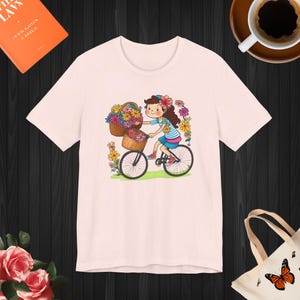 A girl with basket of flowers on a bicycle, Soft Airlume combed and ringspun cotton, Unisex Jersey Short Sleeve Tee