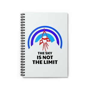 May include: A white spiral notebook with a blue and red rocket design and the text "The sky is not the limit".