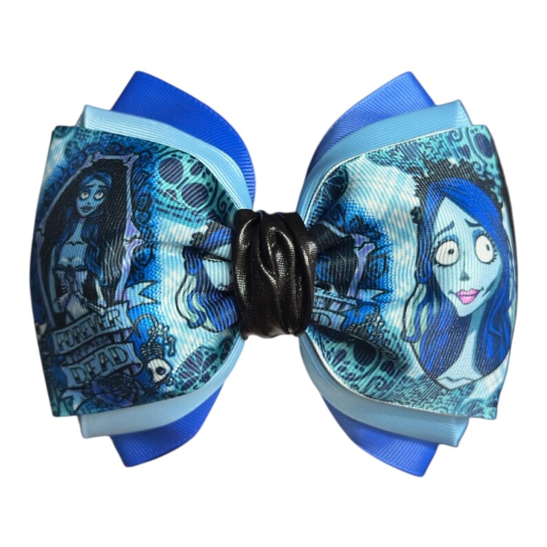 May include: A layered hair bow featuring a blue-toned illustration of a character with blue skin and hair. The bow has a black center and is made of various shades of blue ribbon. The words "Forever Dead" are visible on the bow.
