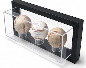 May include: A rectangular black display case with a clear acrylic front containing three white baseballs on individual clear stands. Each baseball features handwritten black ink text, including phrases like Good job, 1st Home run 5/17/15, and 1st HR 9-11-19.