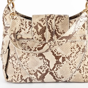 May include: A set of three ceramic mugs with a speckled, matte finish. The mugs are in shades of cream, light gray, and dark gray. Each mug has a simple, minimalist design, perfect for coffee or tea.