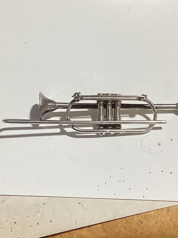 Silver trombone pin