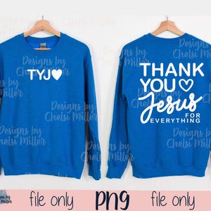 May include: Two blue sweatshirts are displayed, each with white text. One says "TYJ ♡" and the other says "THANK YOU ♡ Jesus FOR EVERYTHING." Both sweatshirts are hanging on wooden hangers. The bottom of the image says "file only png file only."