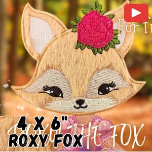 May include: Embroidered 4x6 inch applique of a fox with a pink rose and green leaves on its head. The fox is brown and has black eyes and a black nose. The text "ROXY FOX" is below the fox.