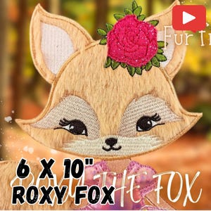 May include: Embroidered applique of a fox with a pink flower on its head. The fox is 6 inches by 10 inches and is called "Roxy the Fox".