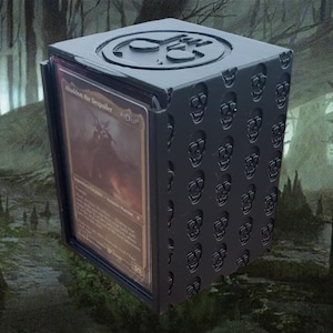 May include: Black card deck box with a skull pattern and a black and gold card inside. The card is titled "Abaddon the Despoiler".