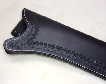 May include: Black leather holster with white stitching and an intricate embossed design.