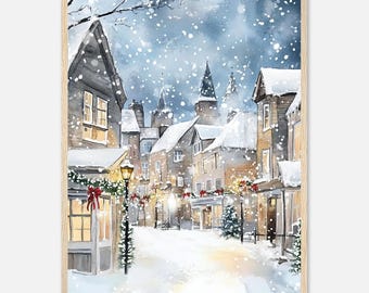 May include: A framed watercolor print depicting a snowy village street at twilight. The scene features multi-story buildings with snow-covered roofs, glowing windows, and festive greenery adorned with red bows. Snow falls over the cobblestone path.