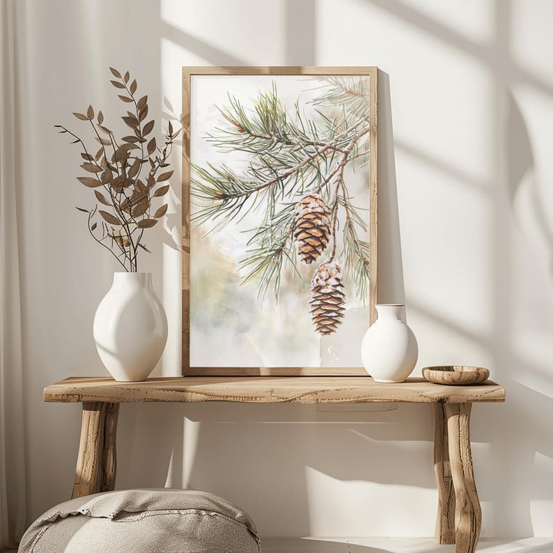 May include: A framed watercolor painting of a pine branch with three pine cones hanging from it. The background is a soft, watercolor wash of green and white.