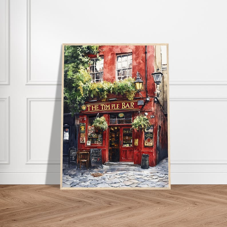 May include: A framed watercolor painting of The Temple Bar in Dublin, featuring a vibrant red facade, green hanging plants, dark window frames, and a cobblestone street. The sign above the entrance clearly displays the text THE TEMPLE BAR.