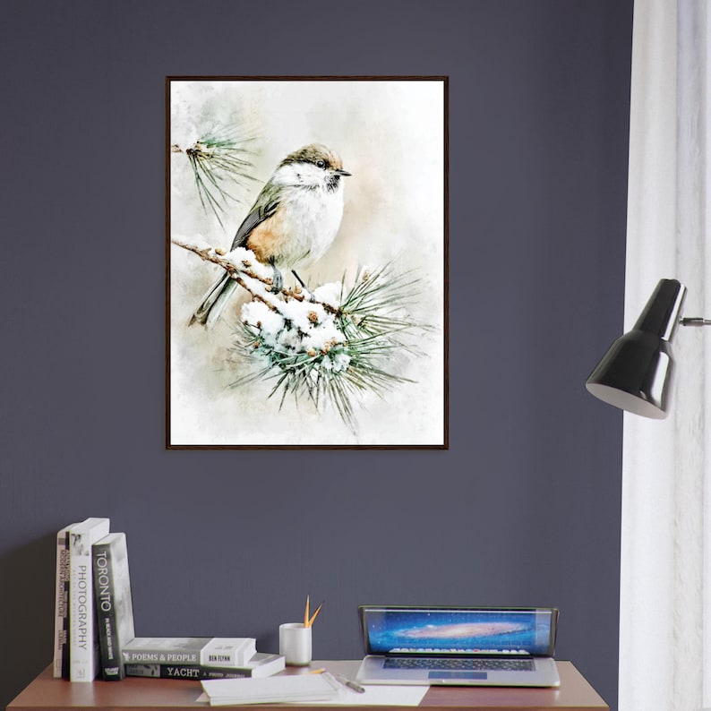 May include: A framed watercolor print of a small bird perched on a snow-covered pine branch. The bird has brown and white feathers, and the artwork has a soft, muted color palette. The print is displayed on a dark blue wall.