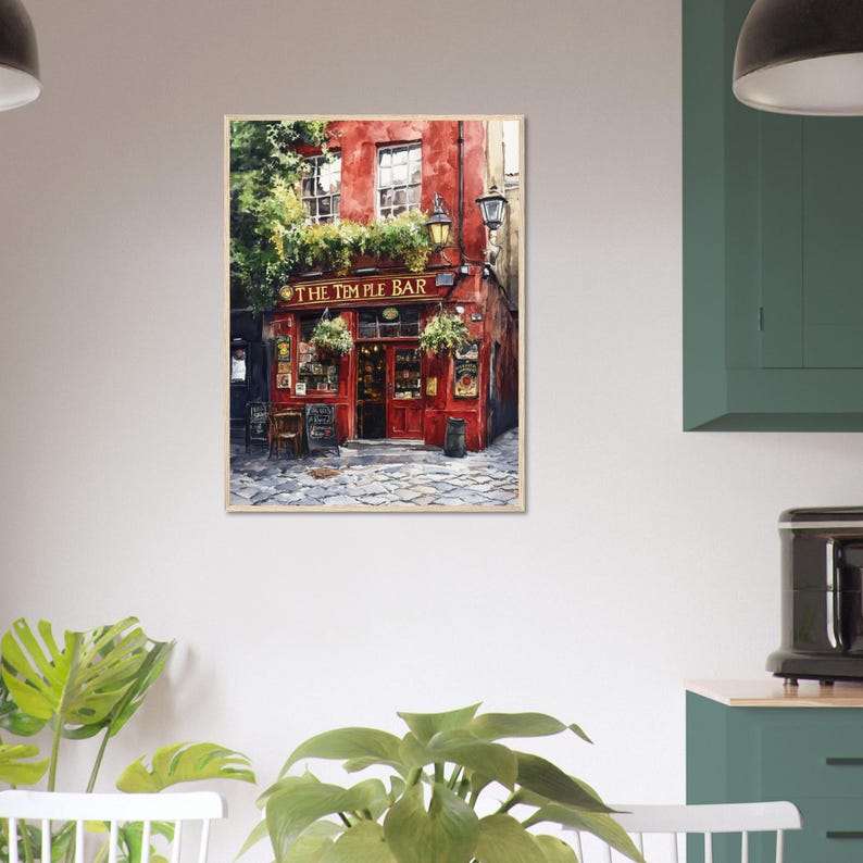May include: A framed wall art print depicting the exterior of The Temple Bar in Dublin, Ireland. The painting features a vibrant red building facade, green hanging plants, dark window frames, and a cobblestone street in a painterly style.