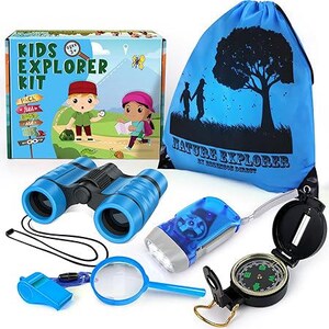 May include: A blue drawstring bag with the text "Nature Explorer by Robinson Direct" printed on it. The bag is filled with a set of explorer tools for kids, including binoculars, a flashlight, a magnifying glass, a whistle, and a compass.
