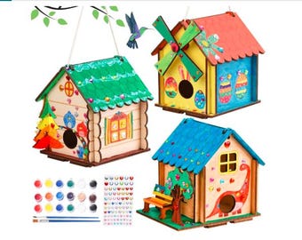 May include: Three wooden birdhouses with colorful paint and embellishments. The birdhouses are ready to be painted and decorated. The set includes paints, brushes, and embellishments.