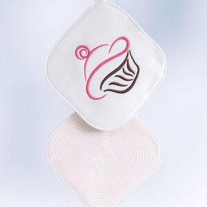 May include: White and pink quilted potholders with a cupcake design. The top potholder has a white background with a pink and brown cupcake design. The bottom potholder is pink with a concentric square pattern.