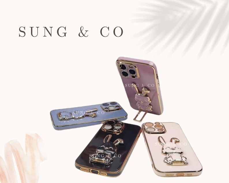 May include: Four different phone cases with a gold trim and a 3D animal design. The cases are pink, blue, black, and white. Each case has the text "SUNG & CO" on the back.