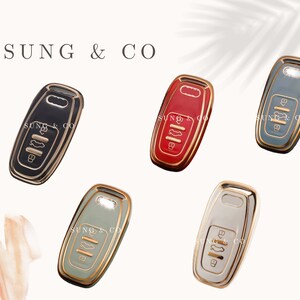May include: Five different colored key covers with gold accents. The key covers are black, red, gray, green, and white.