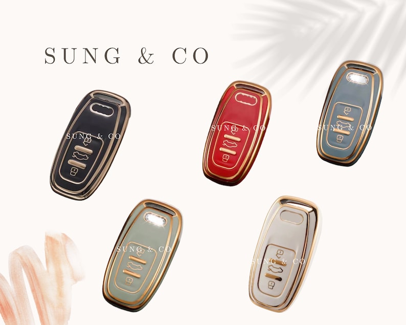May include: Five different colored key covers with gold accents. The key covers are black, red, gray, green, and white.