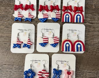 Pendientes patrióticos de celebración del Día de la Independencia. Múltiples opciones de formas: corazón, estrella, flor y lazo. Joyas de colores brillantes y súper livianas.