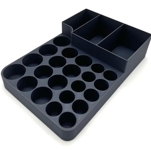 May include: A grey plastic organiser with 24 round compartments and a separate section with three rectangular compartments.