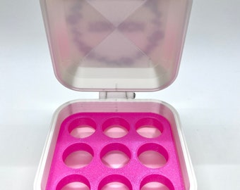 May include: A white plastic storage box with a pink lid and a pink interior. The box has 10 round compartments.