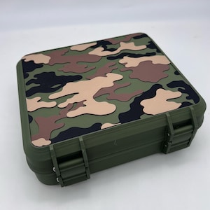 May include: A green, black, and brown camouflage patterned storage box with two latches. The box is made of plastic and has a rectangular shape.