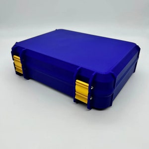 May include: A blue plastic storage case with gold latches. The case has a rectangular shape and is designed for storing small items.