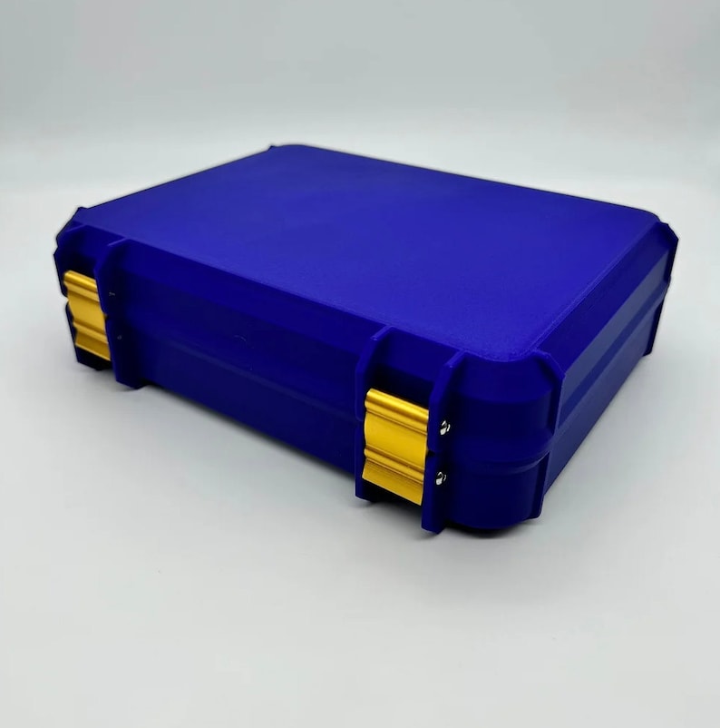 May include: A blue plastic storage case with gold latches. The case has a rectangular shape and is designed for storing small items.