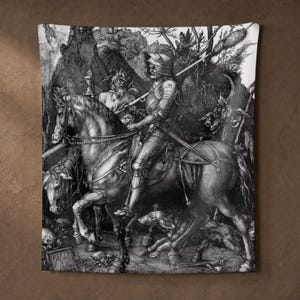 May include: A black and white wall tapestry featuring a detailed engraving of a knight in full plate armor riding a horse. The scene includes a horned figure, a dog, and a skull in a dark, rocky landscape, capturing the classic artwork Knight, Death and the Devil.