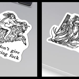 May include: Two black and white stickers. One depicts a mythological scene with the text "I don't give a flying fuck." The other shows figures around a fire, with the text "stay lit."