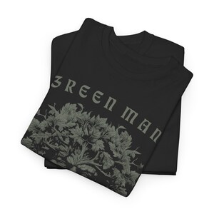 May include: Black t-shirt with a green leafy design and the text "GREEN MAN" printed on the front.