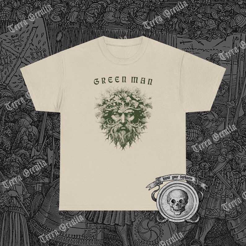 May include: A beige t-shirt with a green man graphic and the text "GREEN MAN" printed on the front. The graphic features a man's face with leaves and branches for hair. Below the graphic is a small banner with the text "know your darkness".