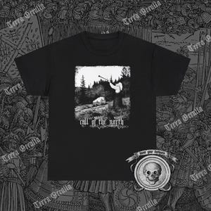 May include: Black t-shirt with a white graphic of a person blowing a horn in a snowy forest. The text "call of the north" is below the graphic. The text "know your darkness" is on a skull graphic in the lower right corner.