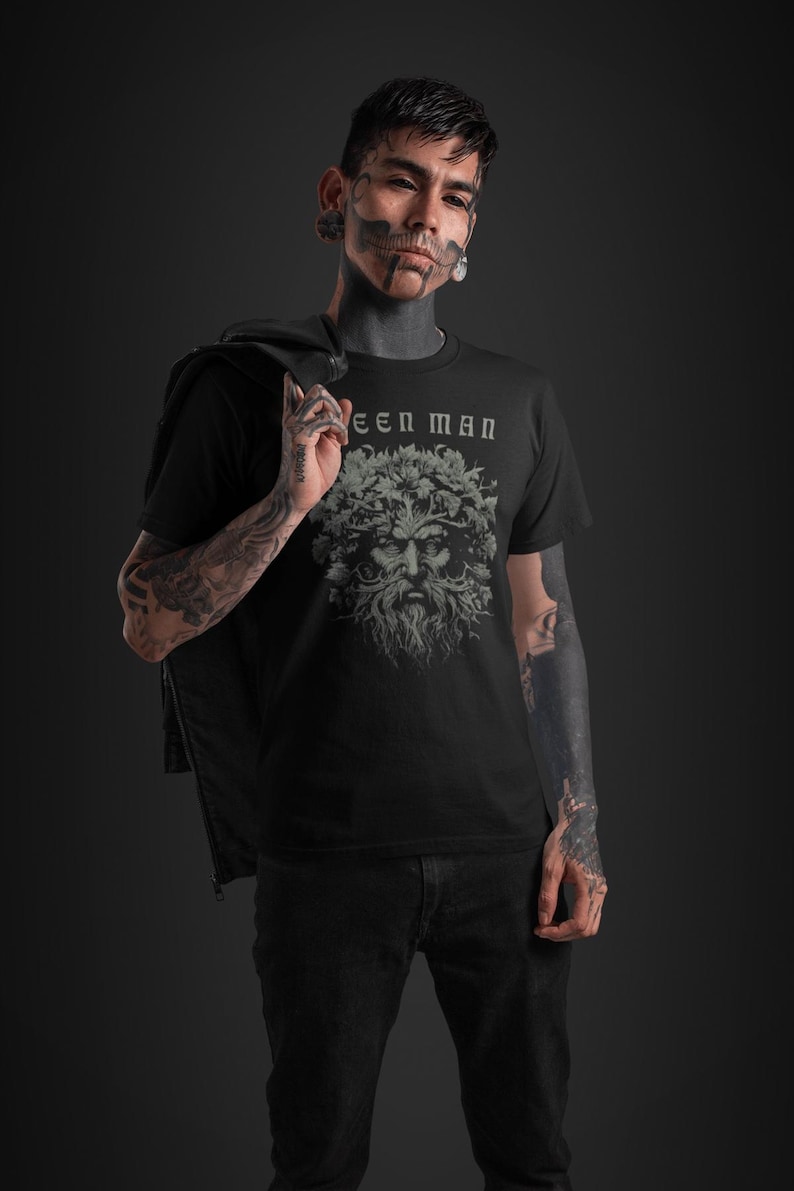 May include: A black t-shirt with a green man graphic and the text "Green Man" printed on the front.