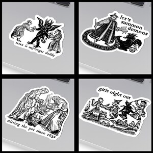 May include: A set of four black and white stickers featuring gothic illustrations. One sticker reads "satan is my sugar daddy", another says "let's summon demons", a third says "stirring the pot since 1632", and the last says "girls night out".