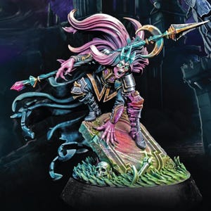 May include: A miniature fantasy figure of a pale-skinned humanoid with long pink and purple hair, wearing dark armor and wielding a spear. The figure is posed on a tombstone with a skull and green foliage.