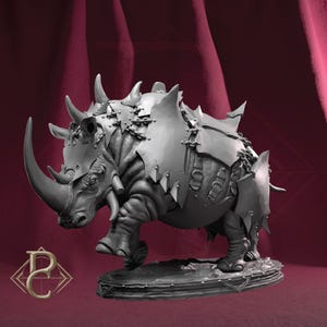 May include: A grey rhinoceros figurine, heavily armored with metal plates and horns. The rhino stands on a textured base, with the armor secured by rivets and chains. The design suggests a fantasy or gaming theme, with a detailed finish.