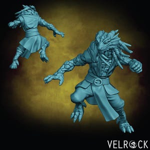 May include: Two teal-colored fantasy figurines of a humanoid dragon-like creature in a dynamic pose. The figures have detailed scales, claws, and a belt. The logo "VELROCK" is visible in the bottom right corner.