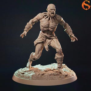 May include: A detailed, beige-colored figurine of a screaming, muscular humanoid creature. The figure is posed mid-stride, with arms outstretched and wrapped in rope. The creature wears a loincloth and has a necklace. It stands on a rocky base.