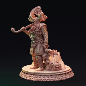 May include: A detailed figurine of a Viking warrior, holding an axe and a curved weapon. The warrior wears a horned helmet and armour, standing on a decorative base. The figurine is in shades of brown and tan, with intricate detailing.