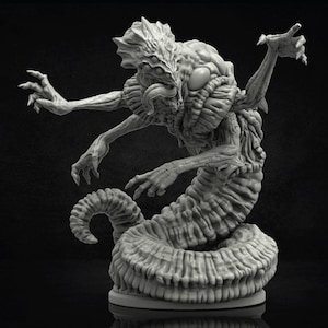 May include: A detailed, grey, three-dimensional sculpture of a monstrous creature. The creature has multiple arms, a segmented body, and a grotesque head with multiple eyes and a large mouth. The sculpture is on a round base.